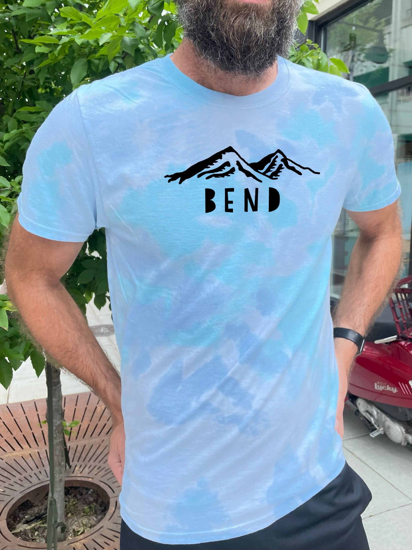 a man with a beard wearing a t - shirt that says bend