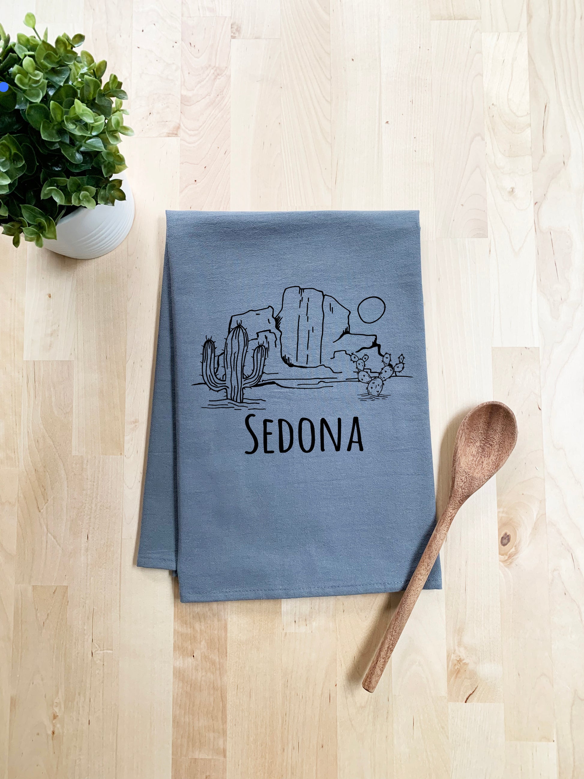a tea towel with a cartoon of sedona on it