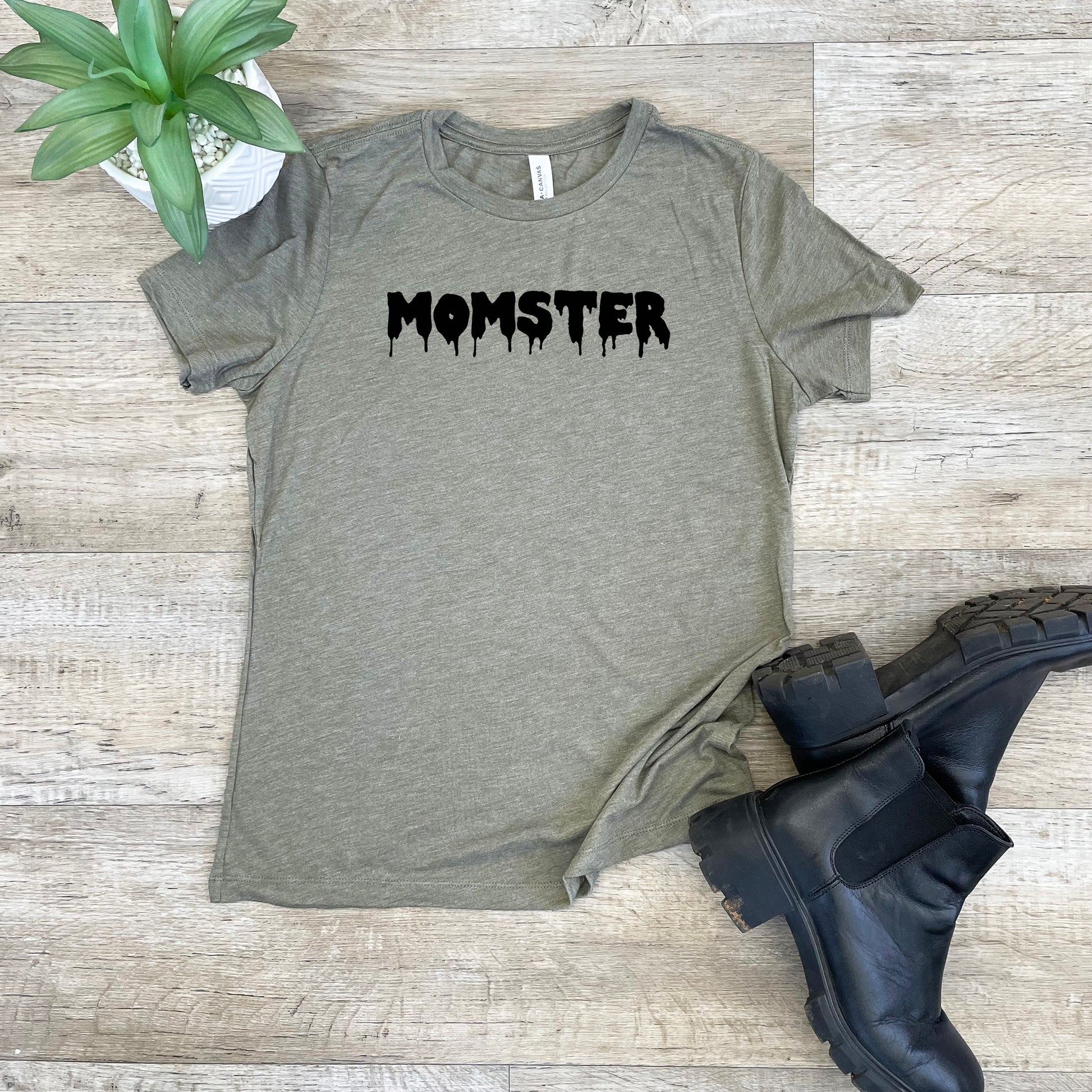 a t - shirt with the word monster on it next to a pair of black