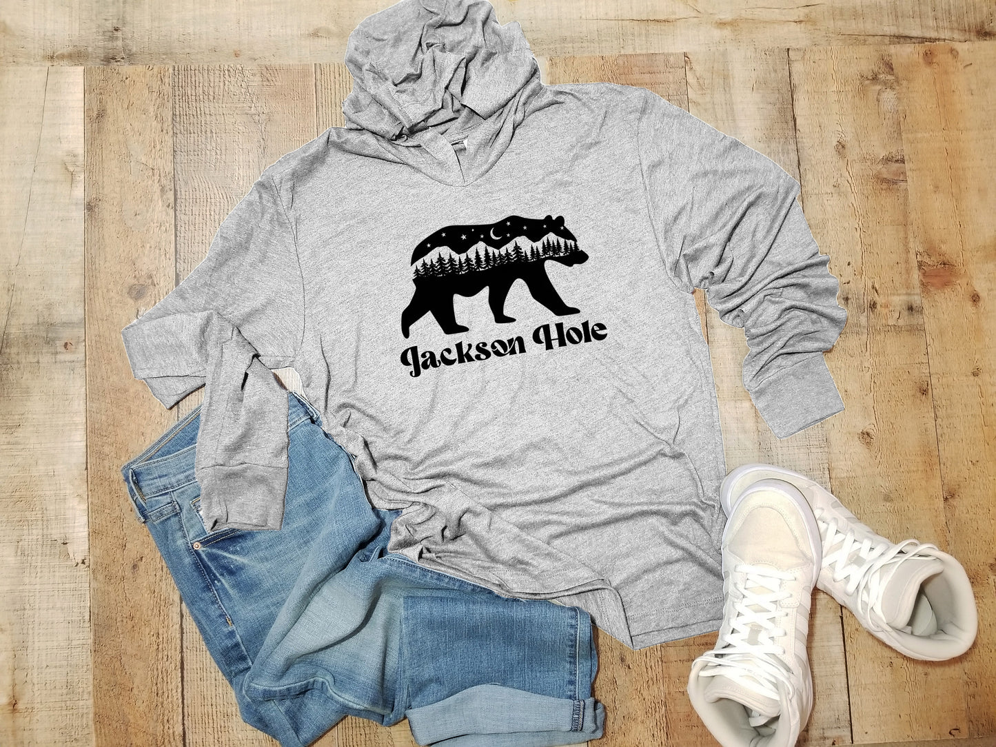 a gray hoodie with a black bear on it