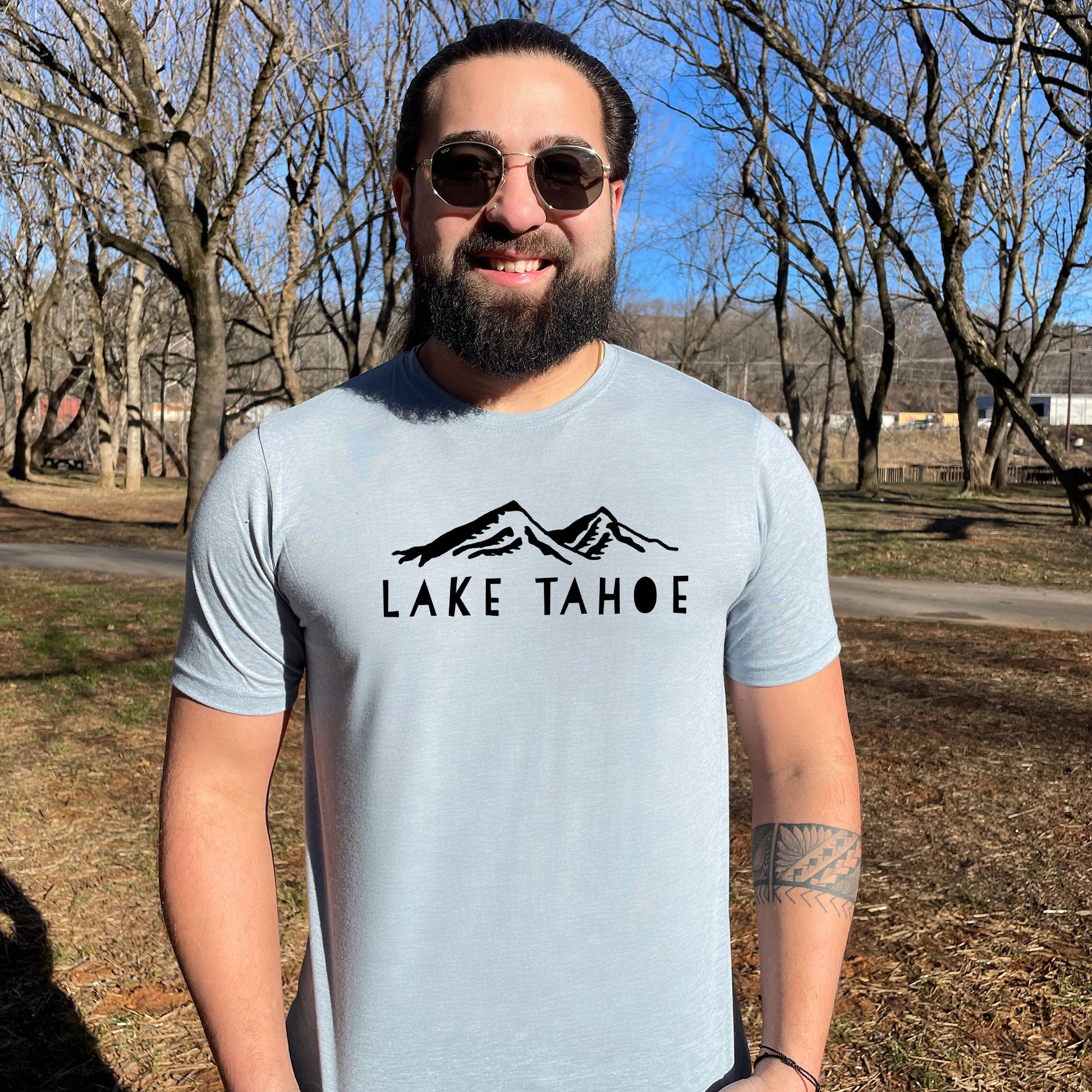 a man with a beard wearing a lake tahoe t - shirt
