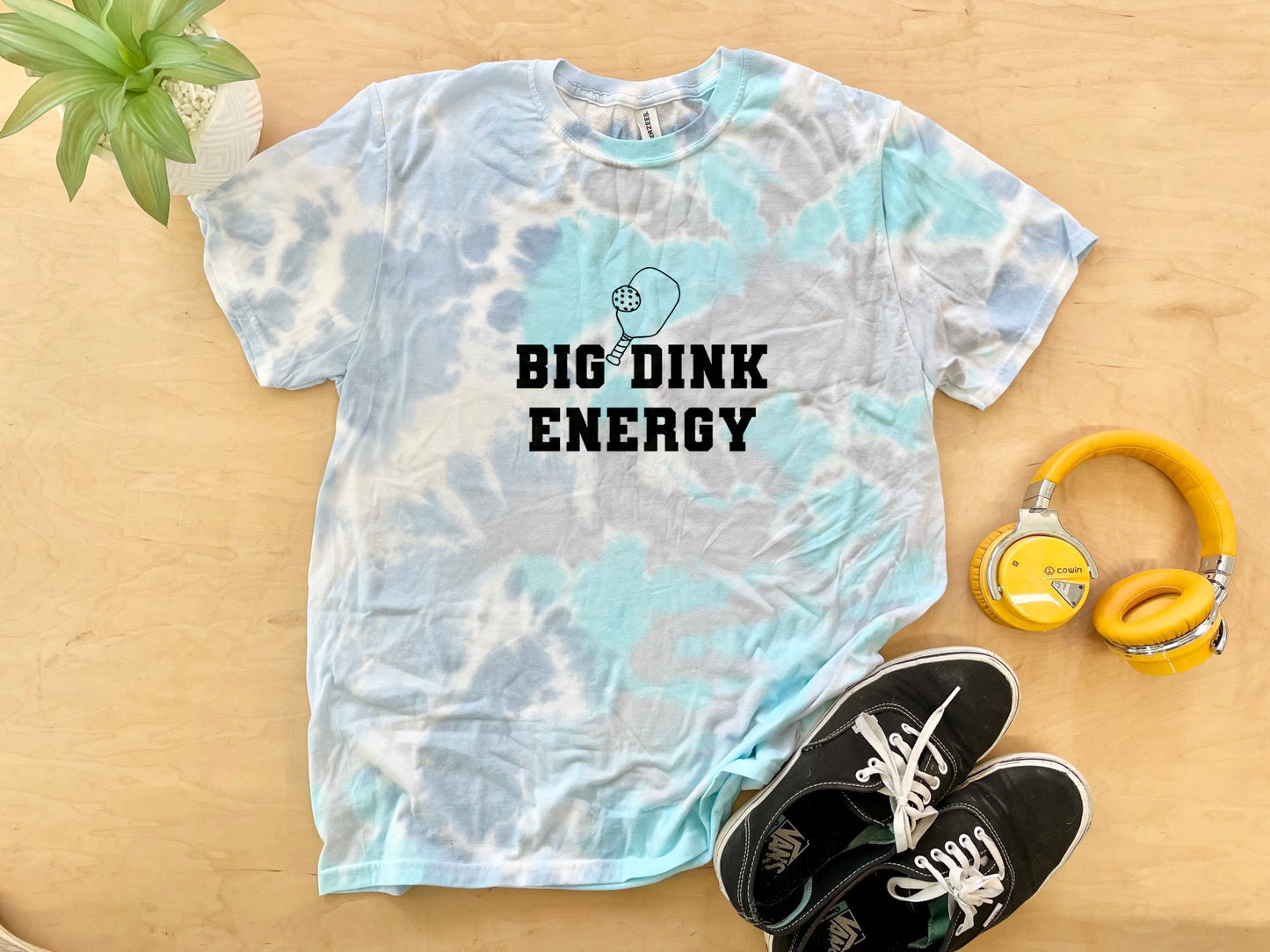 a t - shirt that says, big dink energy next to a pair of