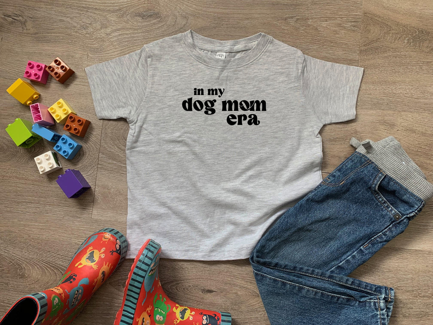 a t - shirt that says in my dog mom era next to a pair of
