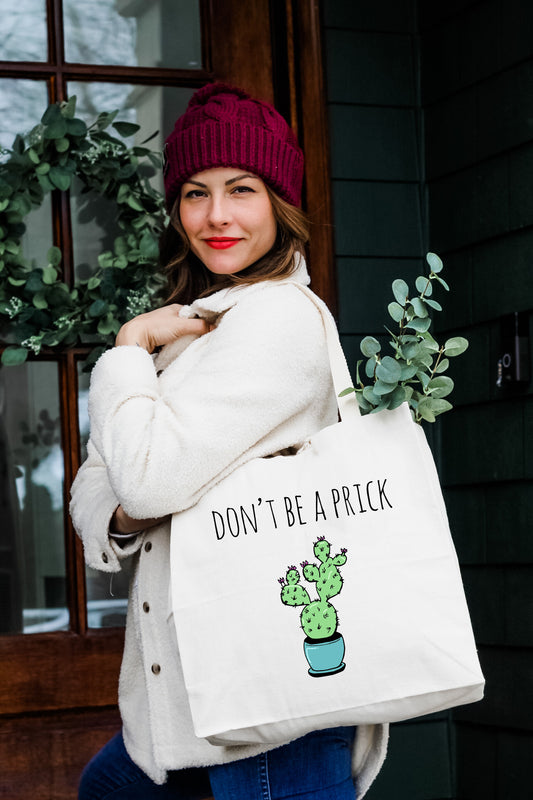 a woman carrying a bag that says don't be a prick