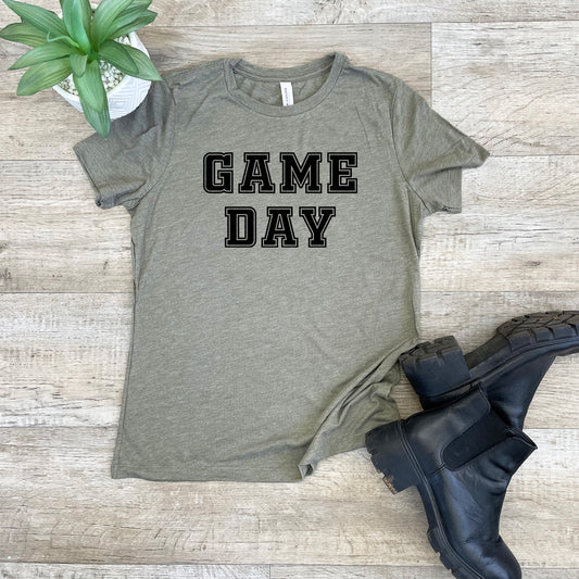 a t - shirt that says game day next to a pair of boots
