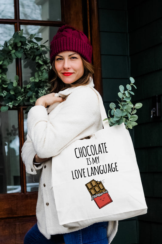 a woman holding a bag with chocolate is my love language