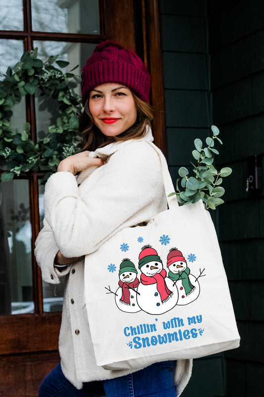 a woman carrying a snowman shopping bag