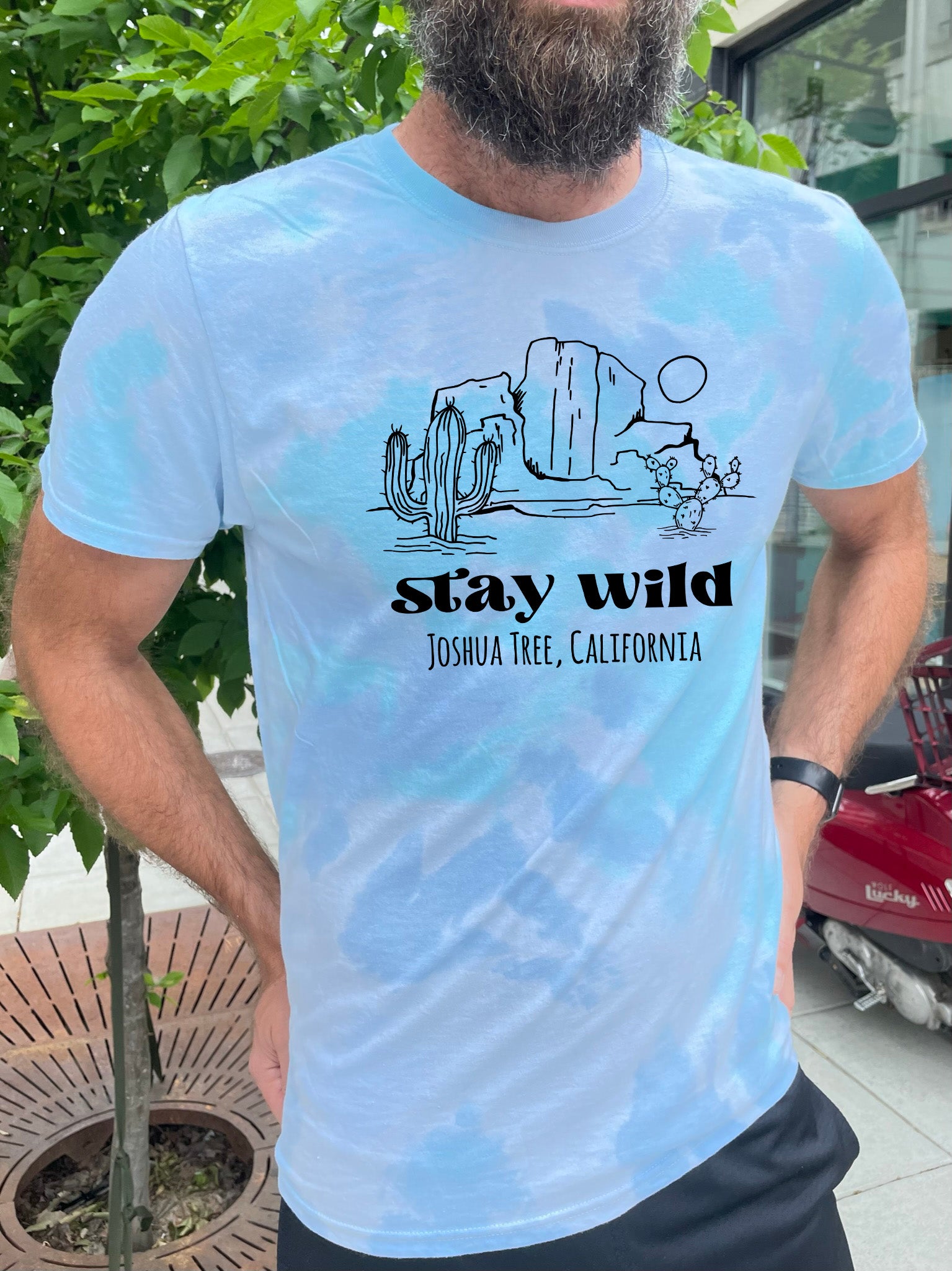 a man with a beard wearing a t - shirt that says stay wild