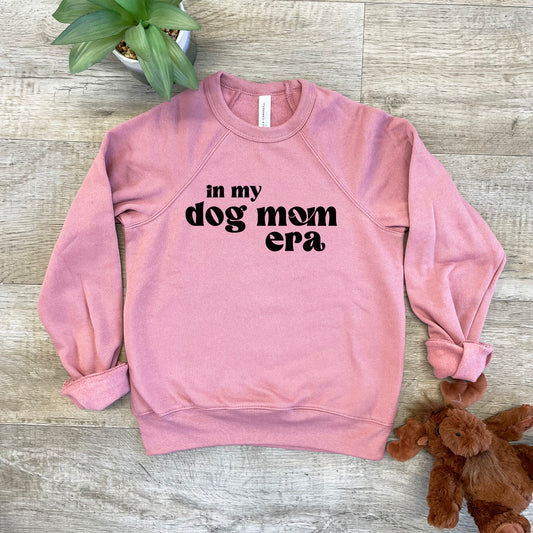 a pink sweatshirt that says in my dog mom era next to a teddy bear