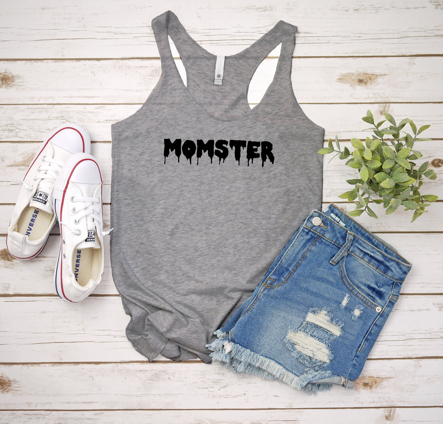 a women's tank top with the word monster on it