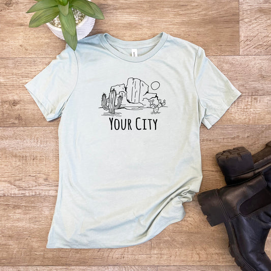 a t - shirt that says your city on it next to a pair of black