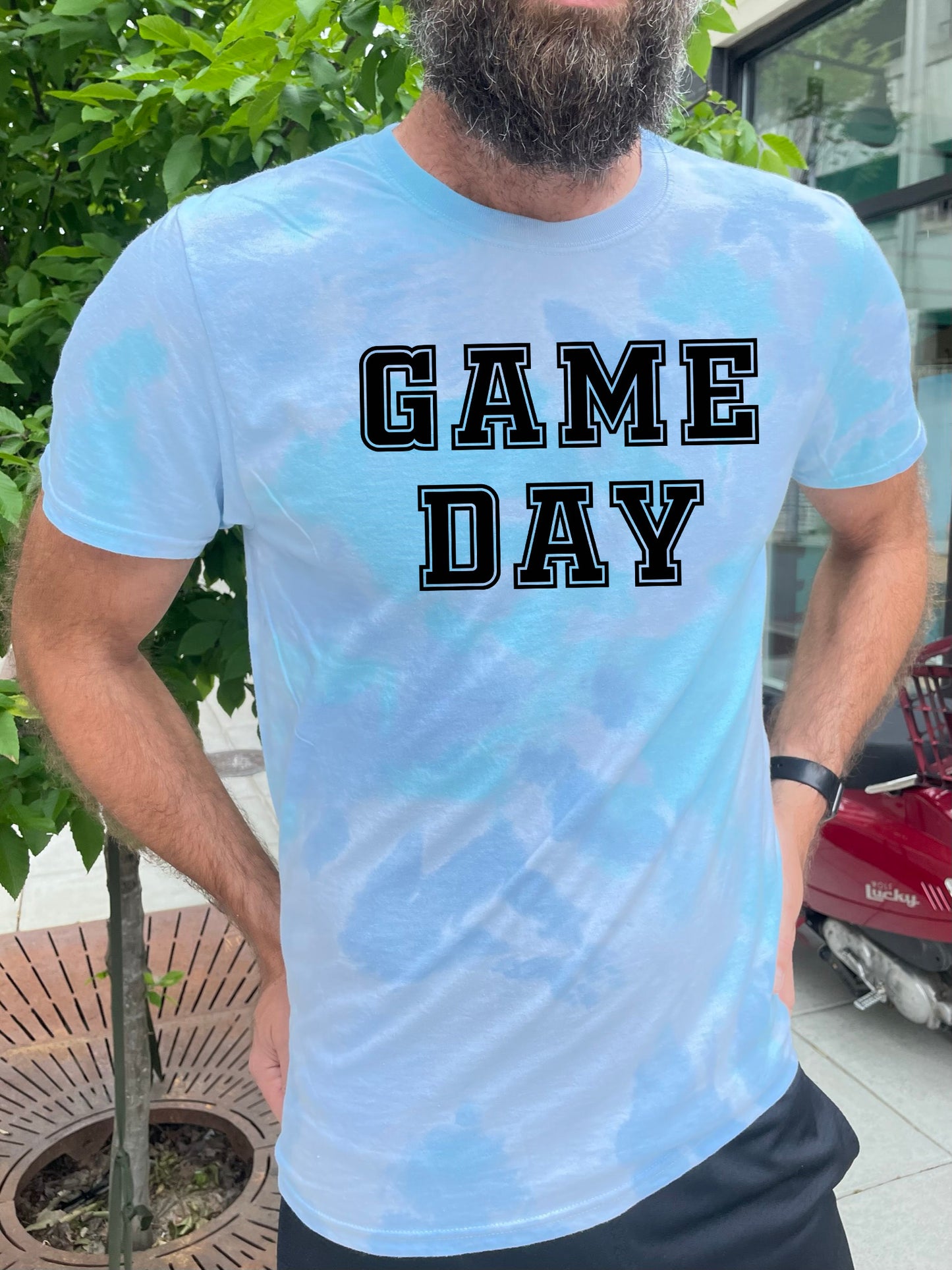 a bearded man wearing a game day t - shirt