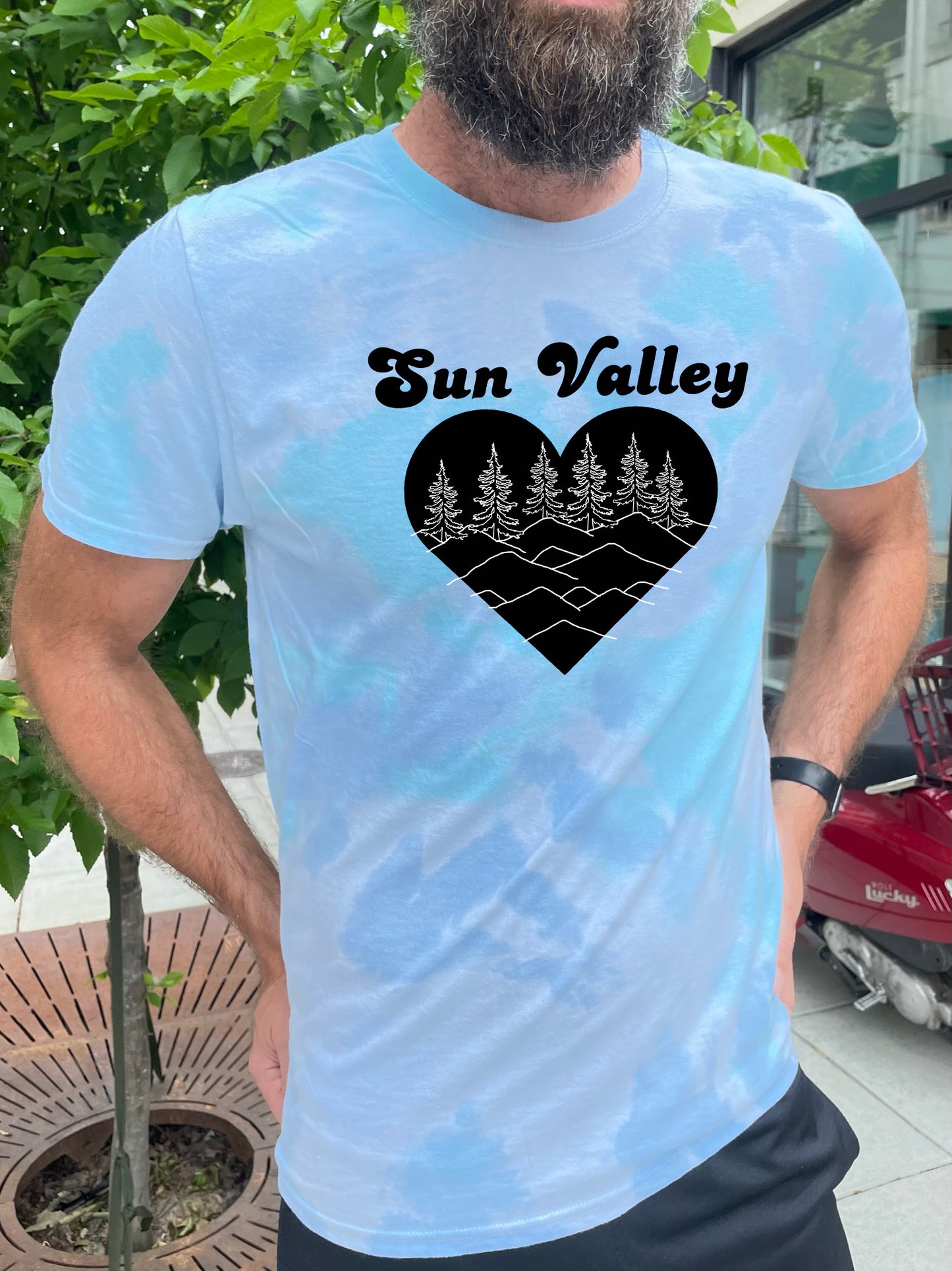 a man with a beard wearing a sun valley t - shirt