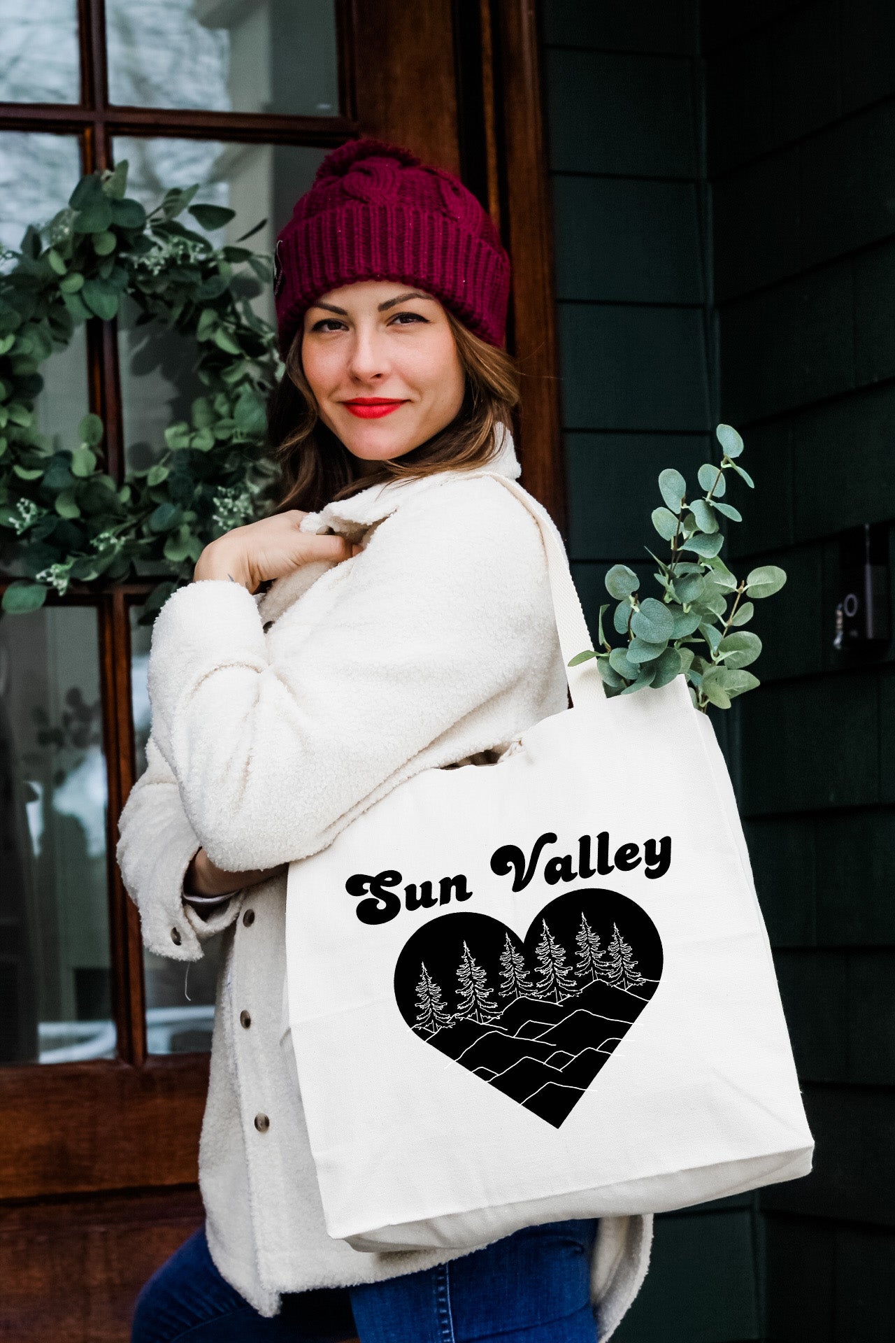 a woman holding a white bag that says sun valley