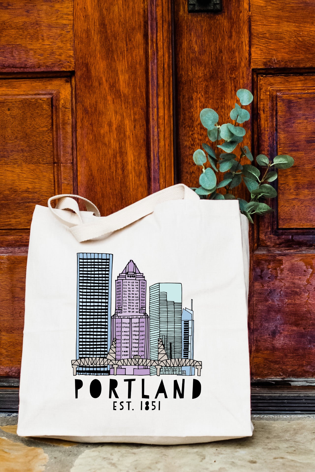 a white bag with a picture of a city on it