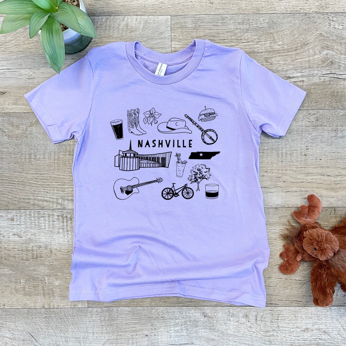 a purple t - shirt with a picture of nashville on it