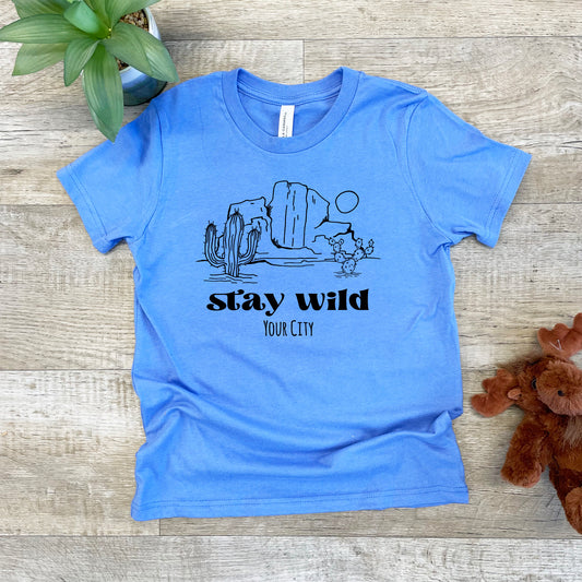 a blue shirt that says stay wild and a teddy bear