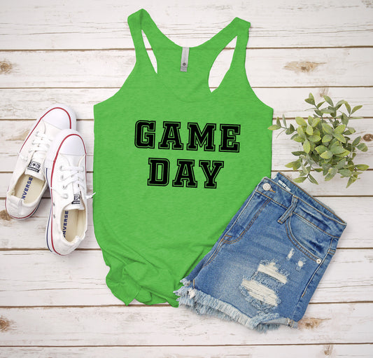 a green tank top that says game day next to a pair of shorts