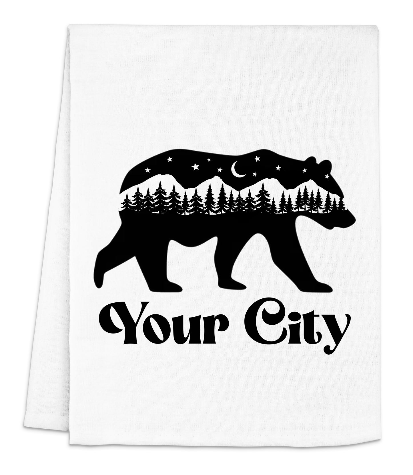 a tea towel with a bear and trees on it