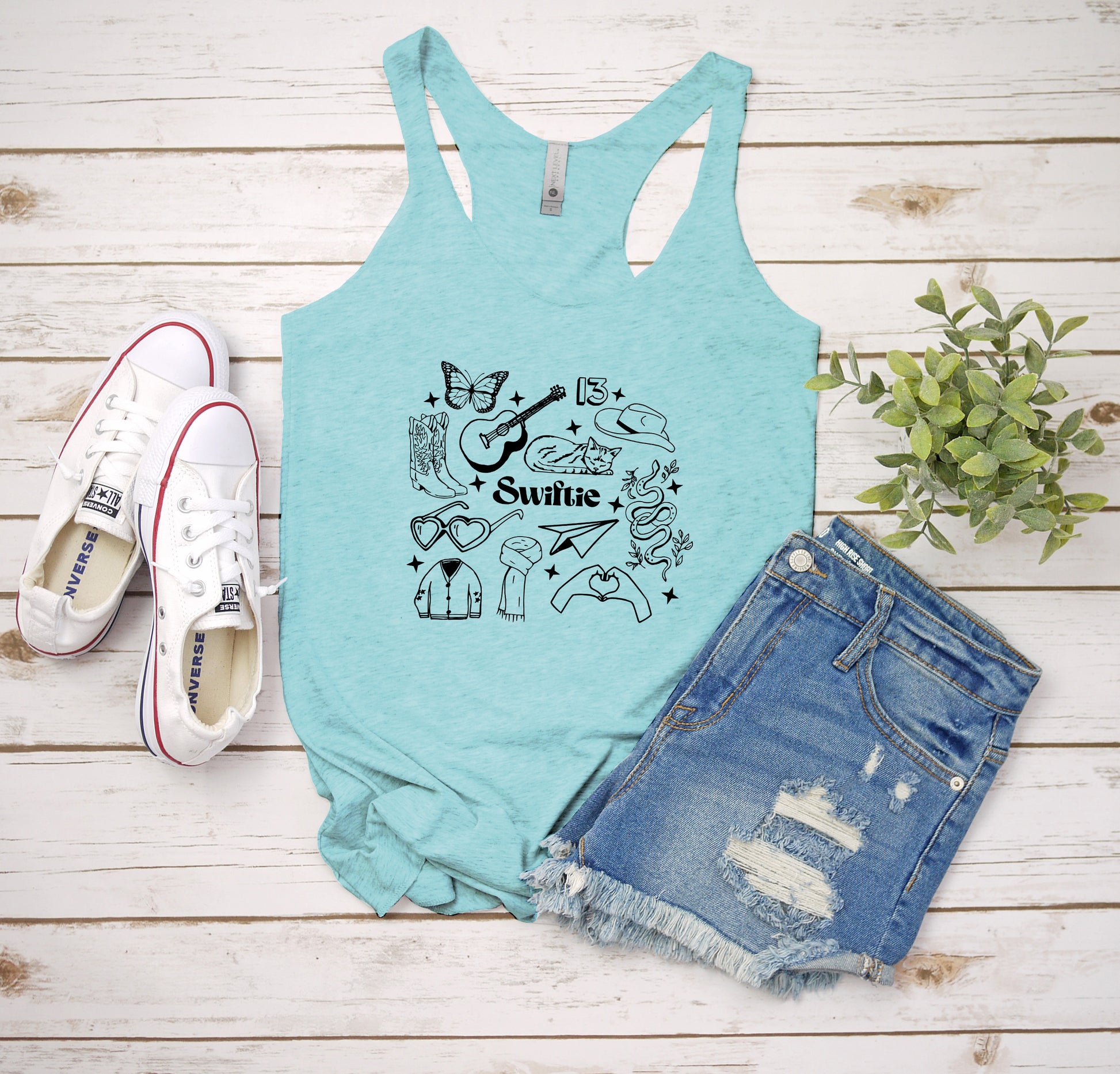 a women's tank top with a graphic of cats and dogs