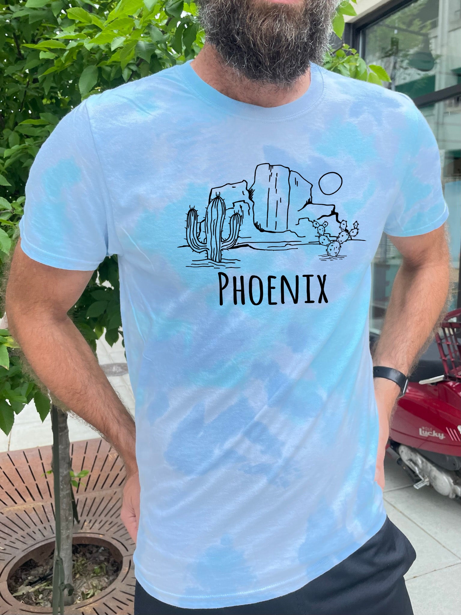 a man with a beard wearing a t - shirt that says phoenix