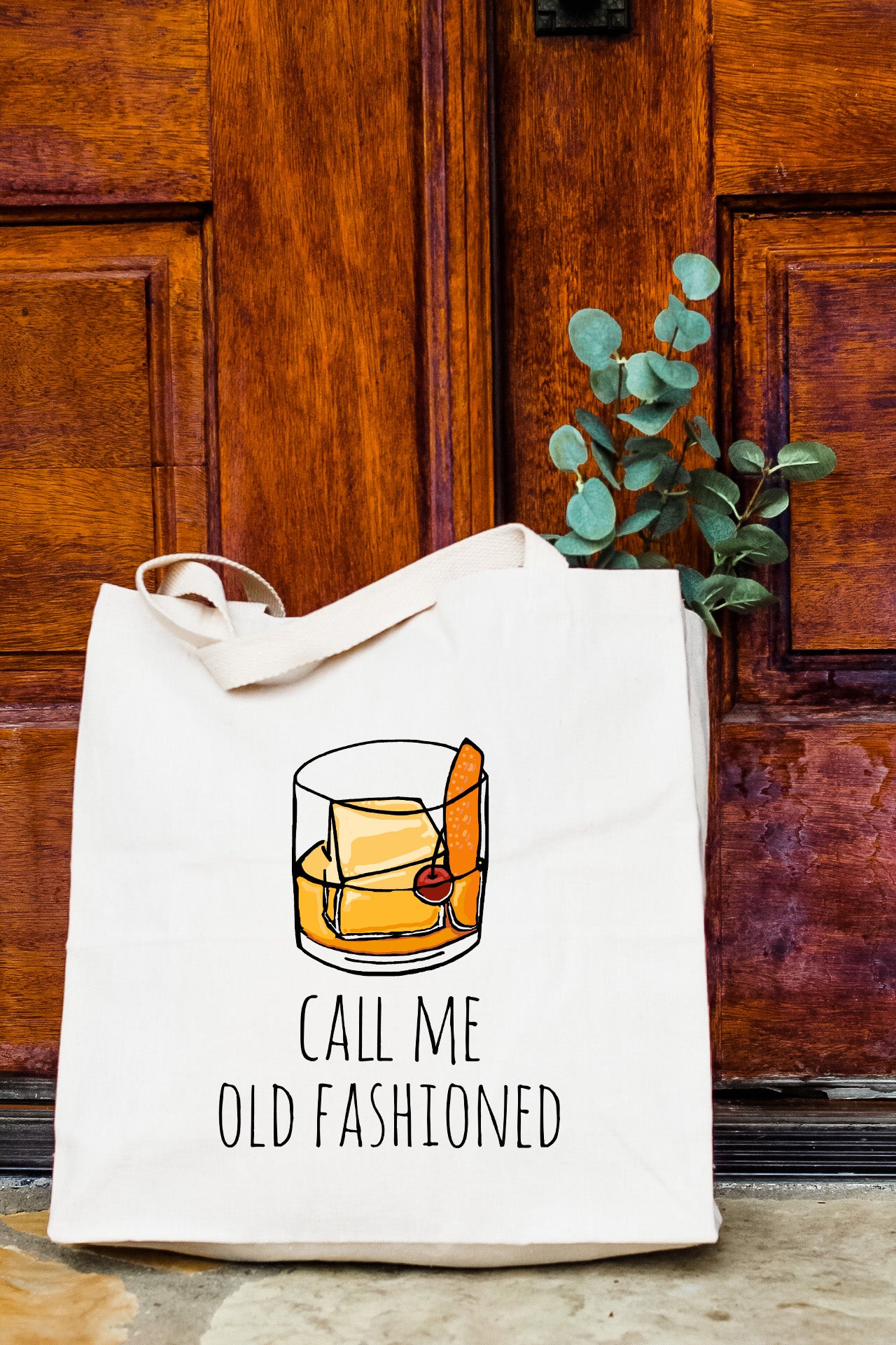 a white bag with a picture of a glass of whiskey on it