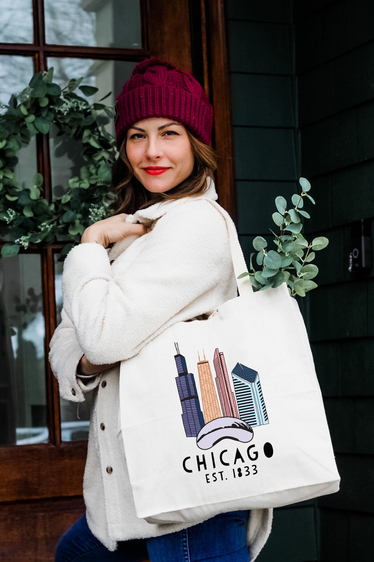 a woman is carrying a chicago shopping bag