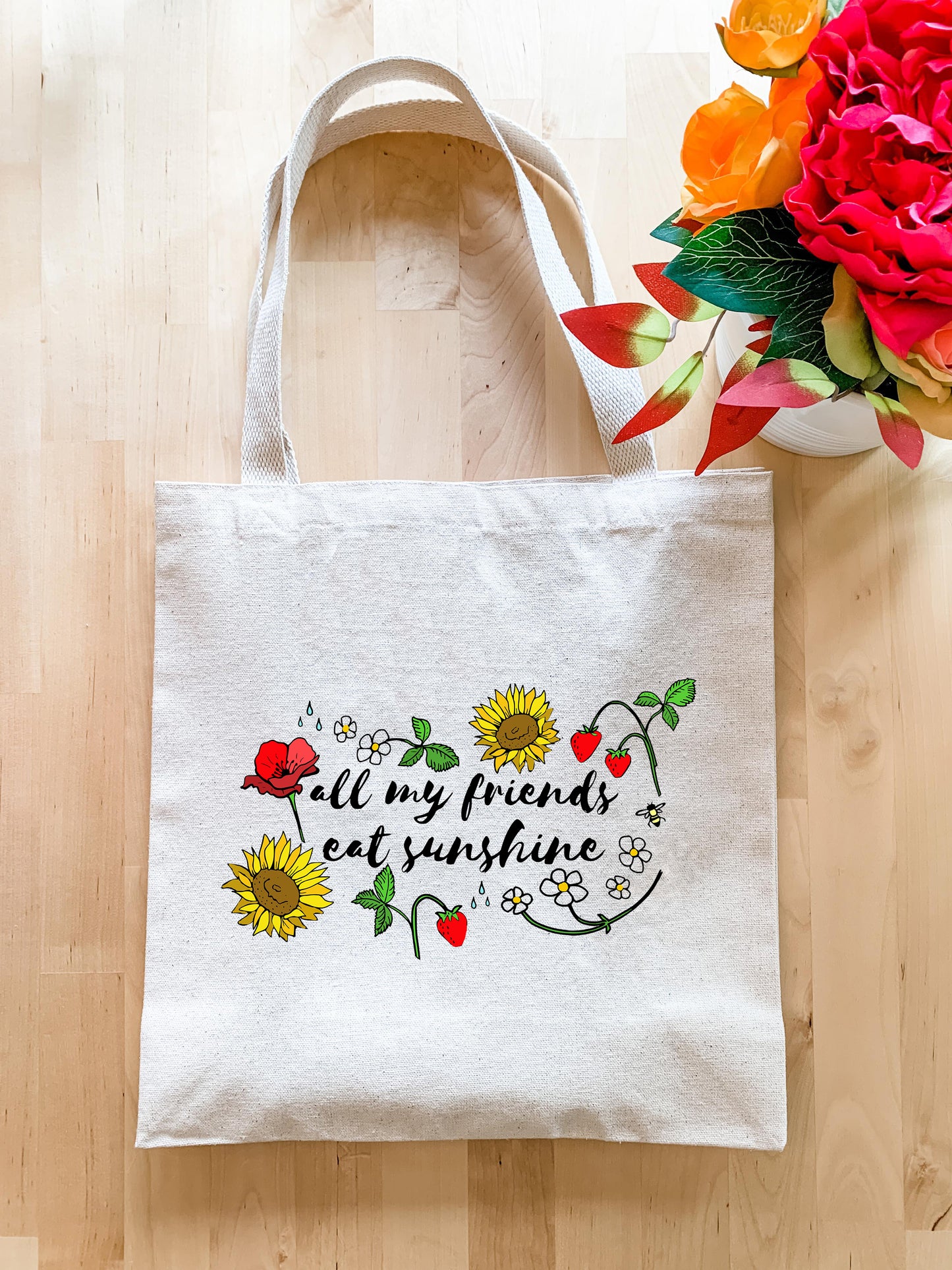 a white tote bag sitting on top of a wooden floor