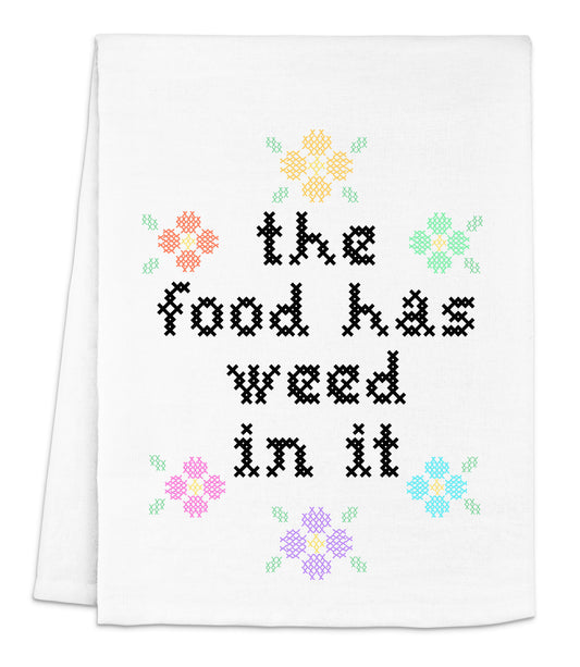 a white dish towel with the words the food has weed in it