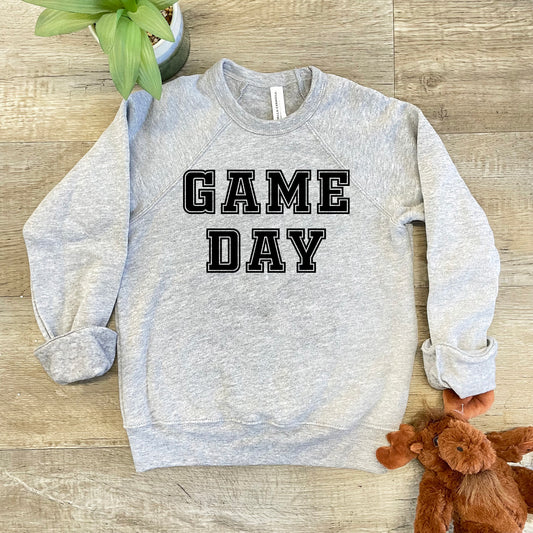 a gray sweatshirt that says game day next to a teddy bear