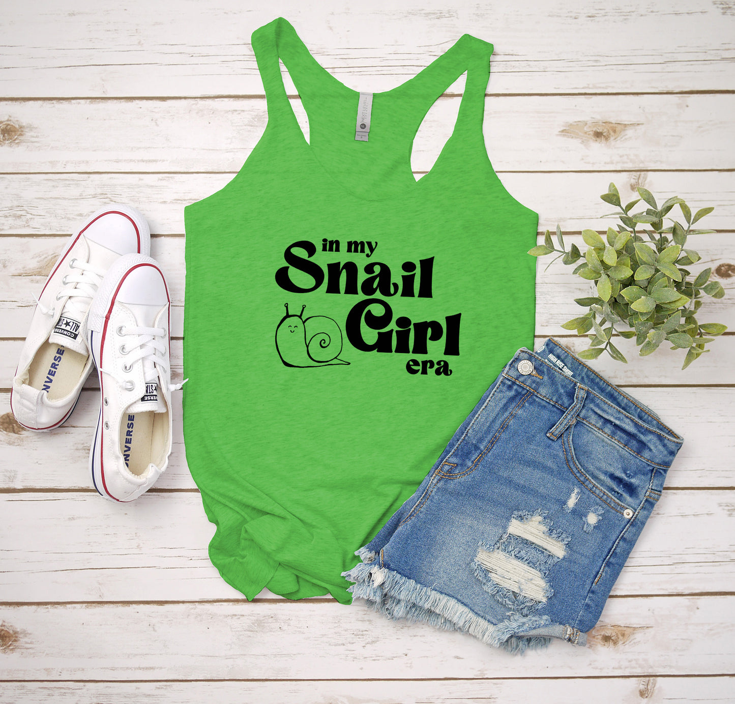 a green tank top that says, in my snail girl era