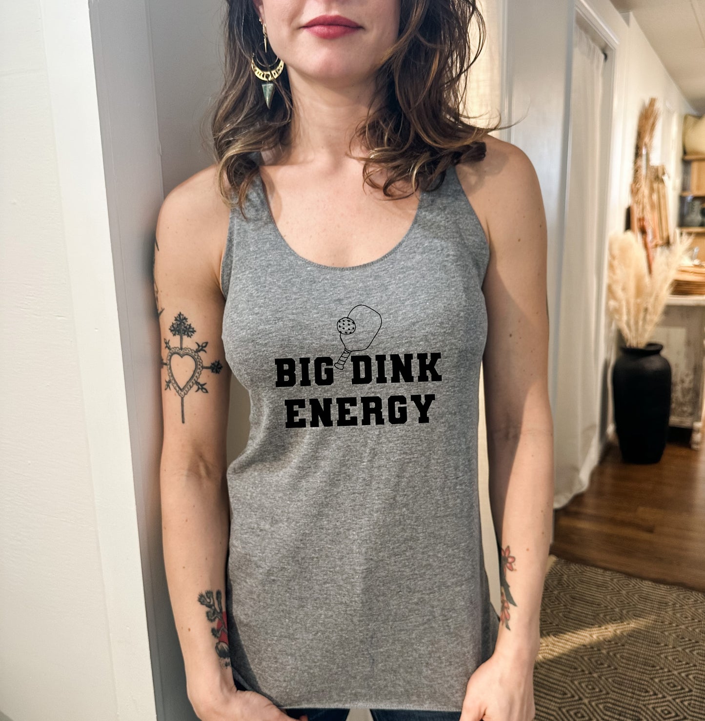 a woman wearing a tank top that says big drink energy