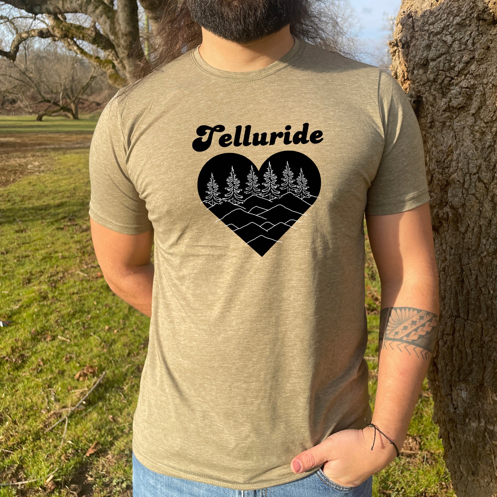 a man with a beard wearing a t - shirt that says telluride