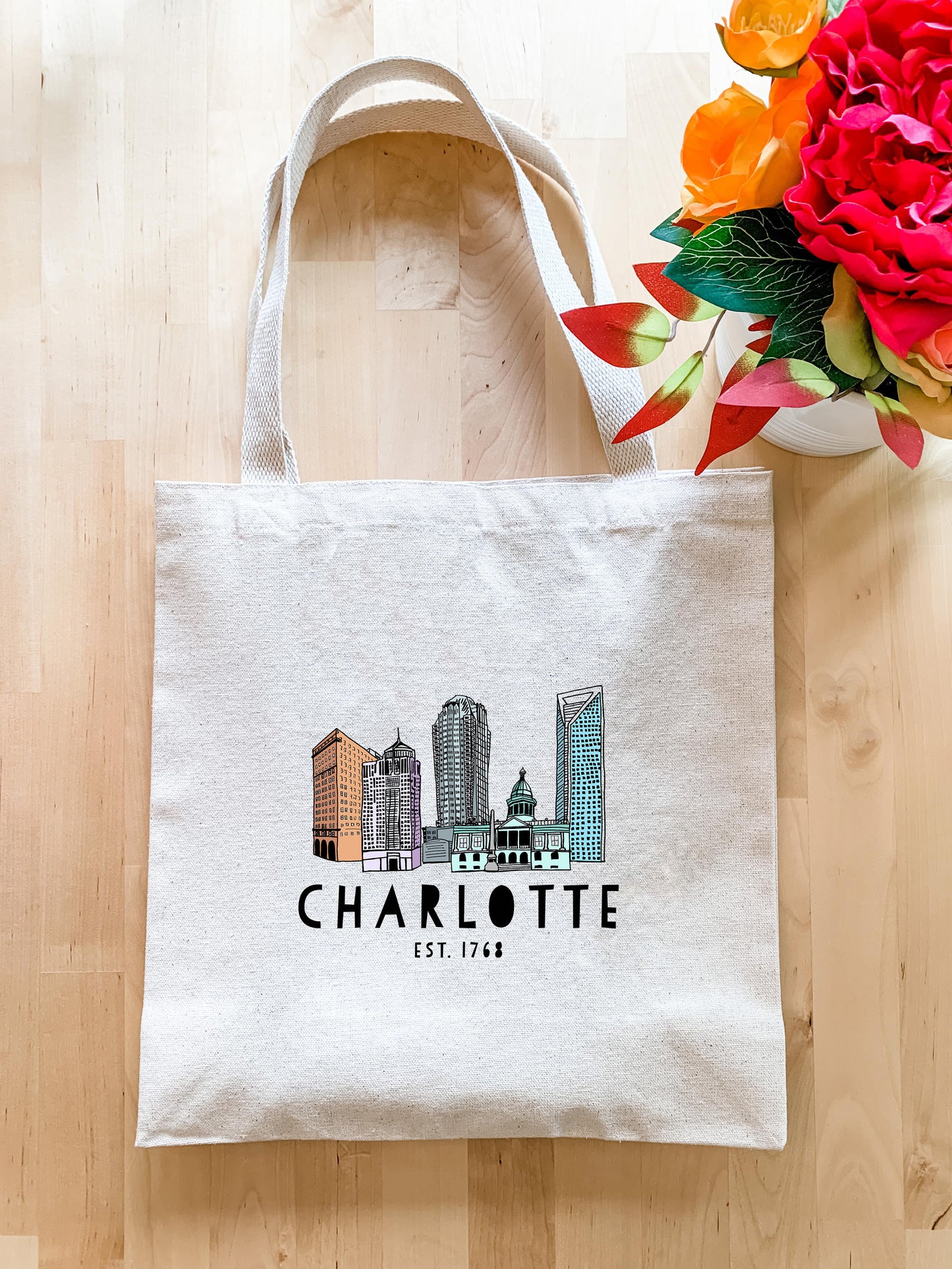 a white bag with a picture of charlotte on it