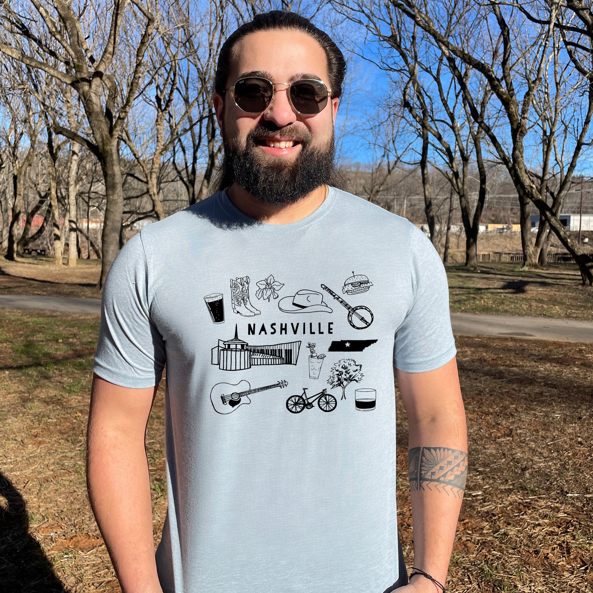 a man with a beard wearing a t - shirt that says nashville