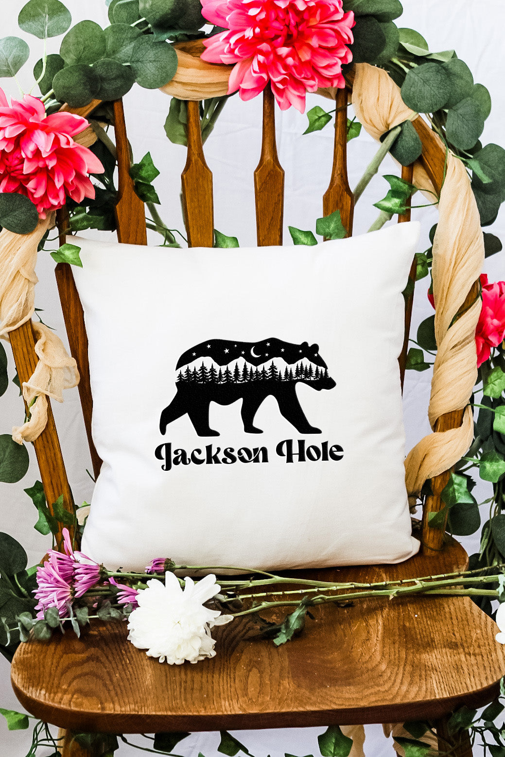 a white pillow with a black bear on it