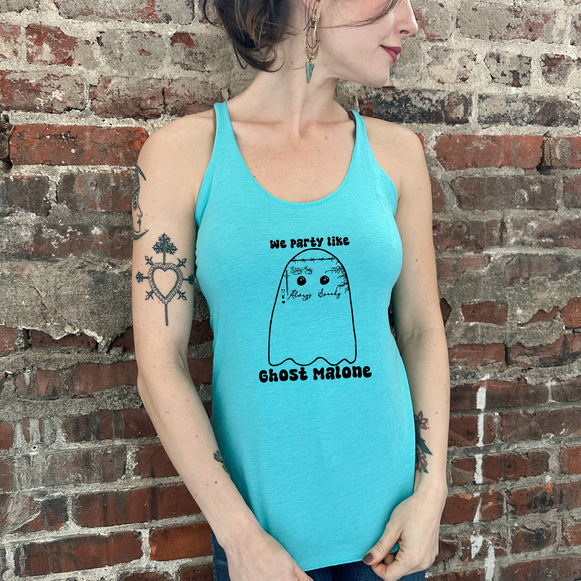 a woman wearing a blue tank top with a ghost on it
