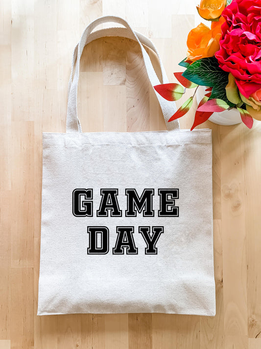 a game day tote bag next to a bouquet of flowers