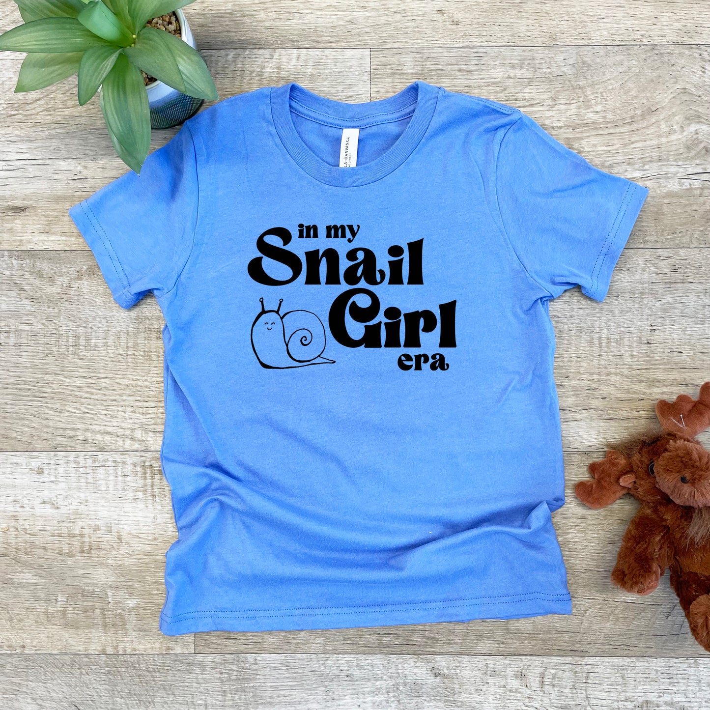 a t - shirt that says in my small girl era next to a teddy bear