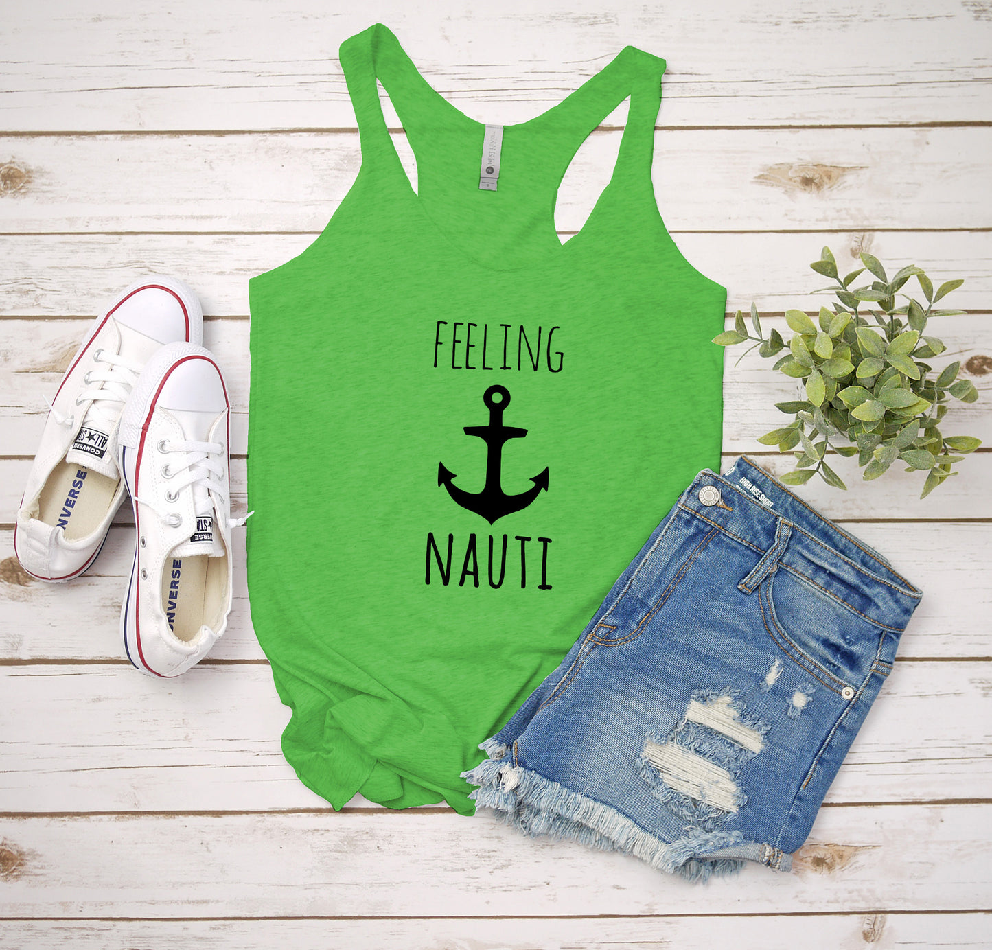 a tank top that says feeling nauti next to a pair of shorts