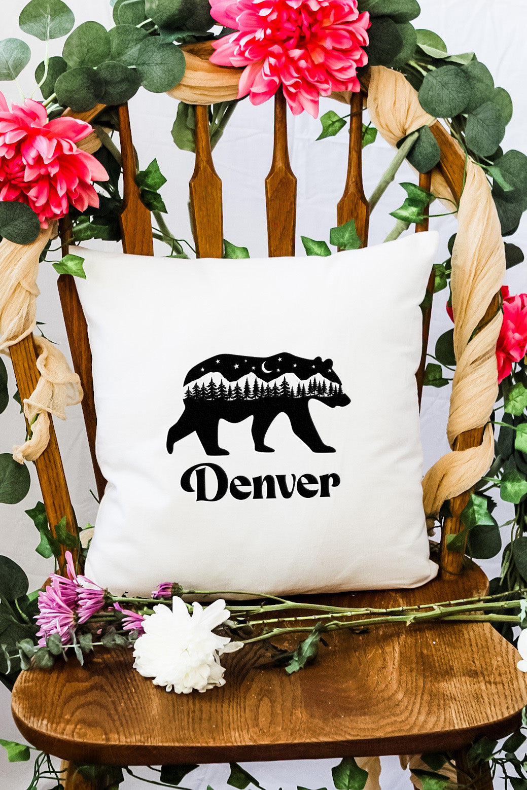 a white pillow with a black bear on it