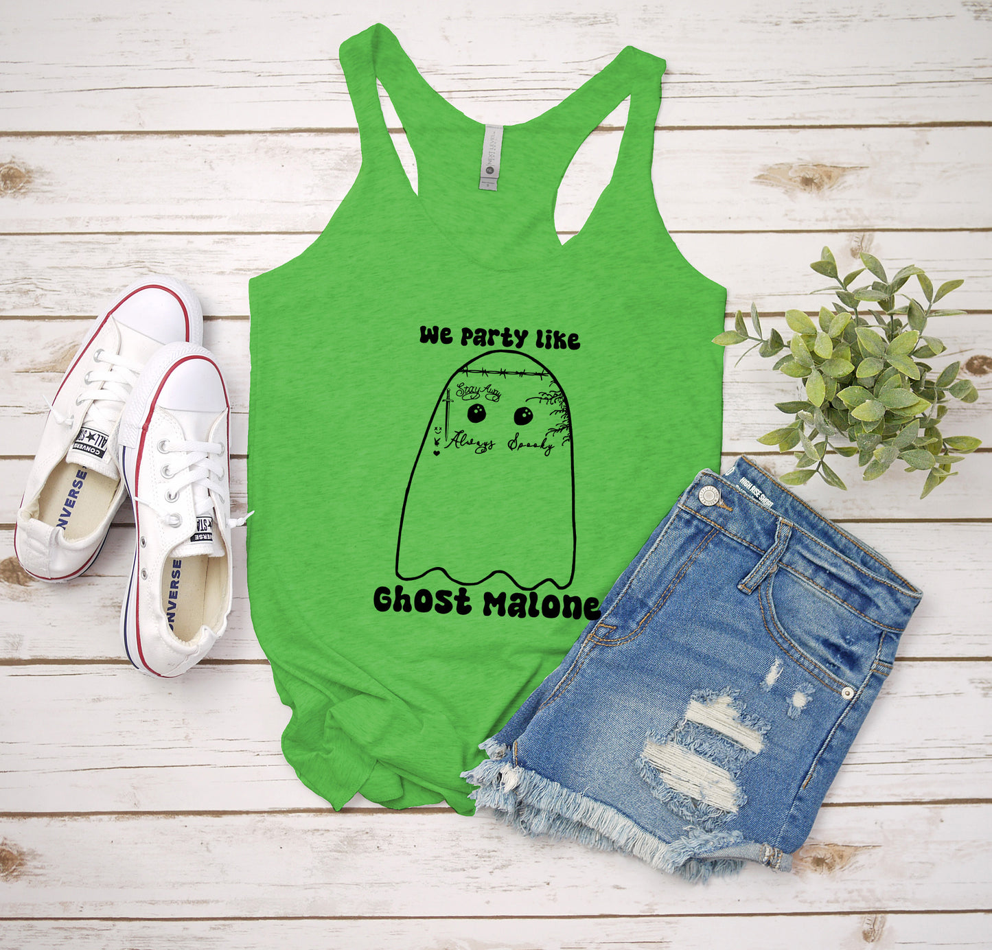 a green tank top that says we party like ghost raison