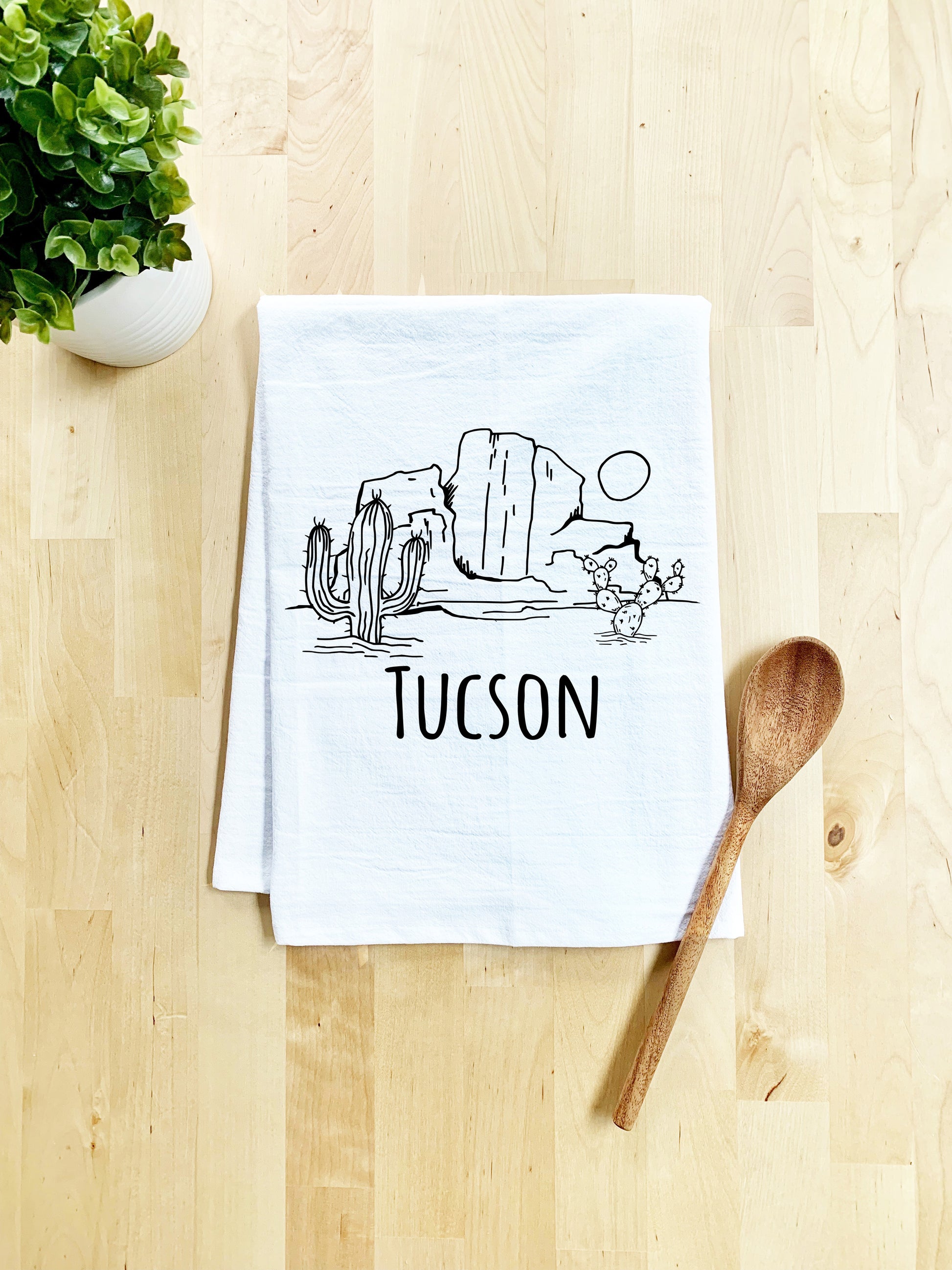 a tea towel with a picture of a cactus on it