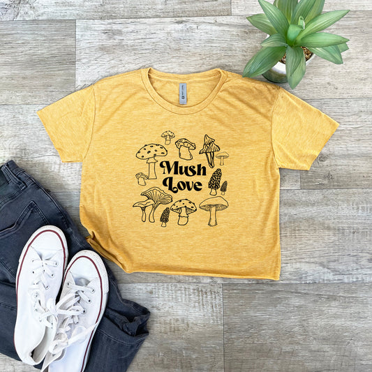 a t - shirt that says mushrooms love on it next to a pair of jeans