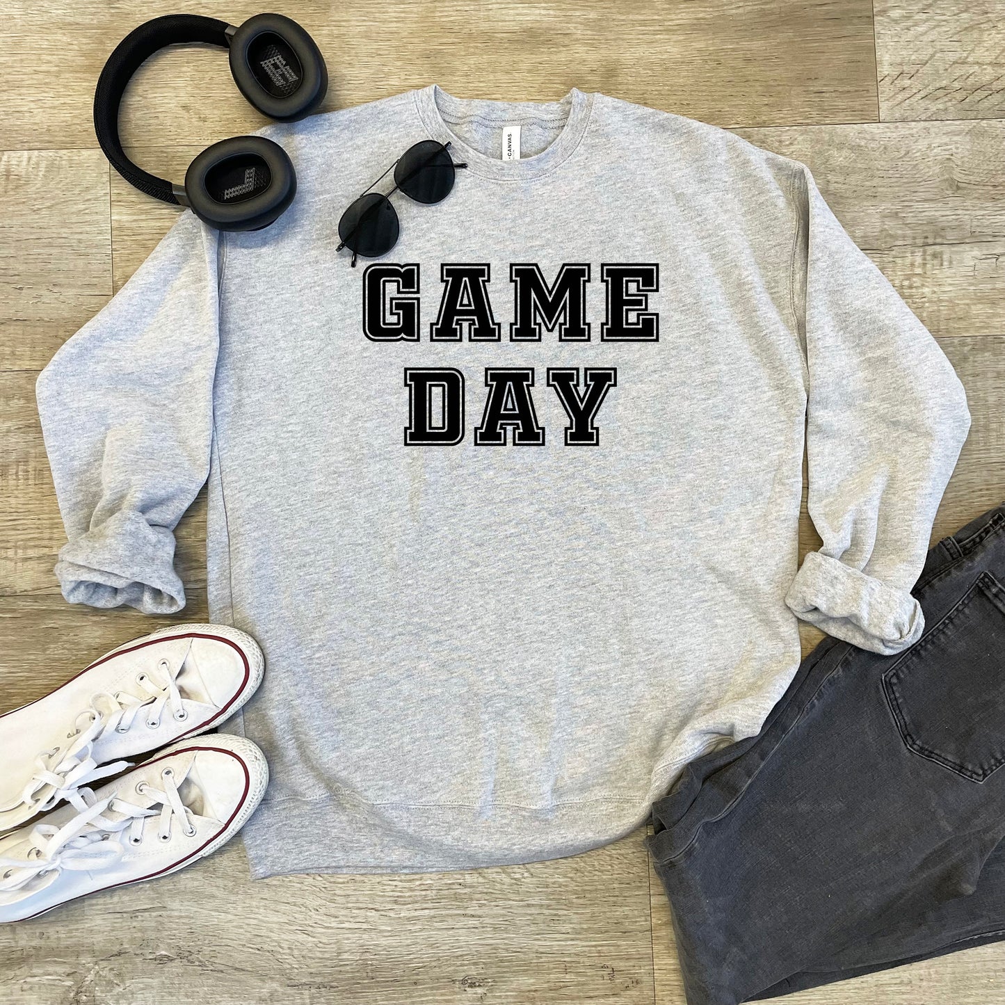 a sweatshirt that says game day next to headphones