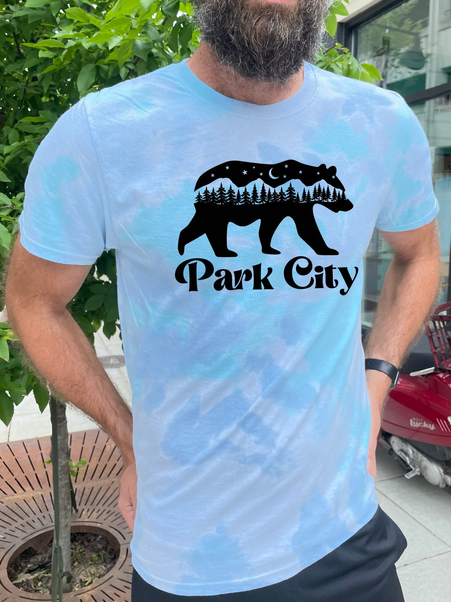a man with a beard wearing a shirt that says park city