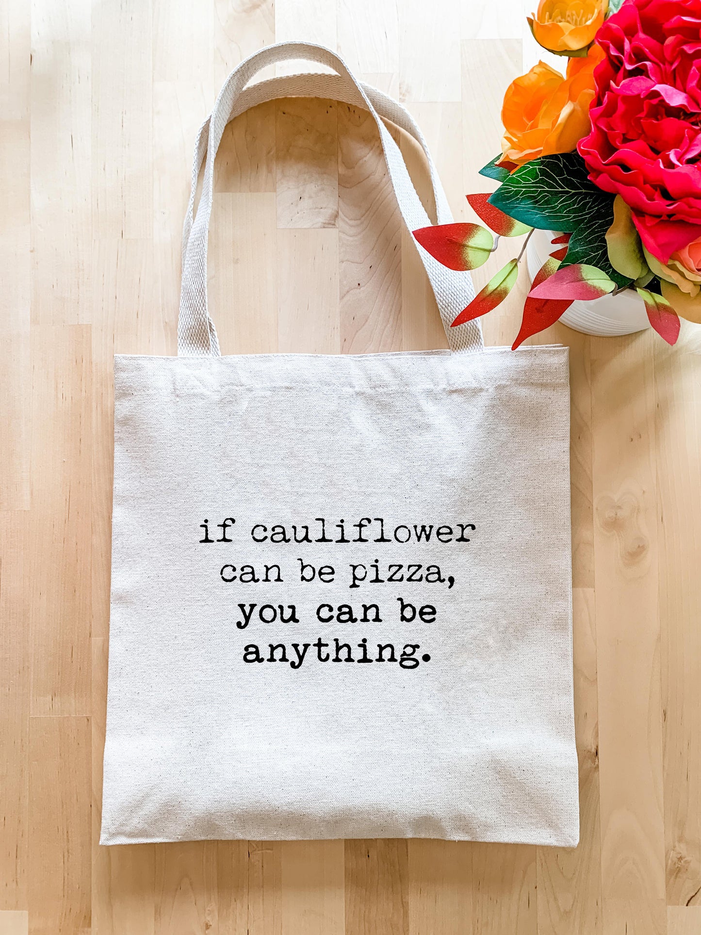 a white tote bag with a quote on it