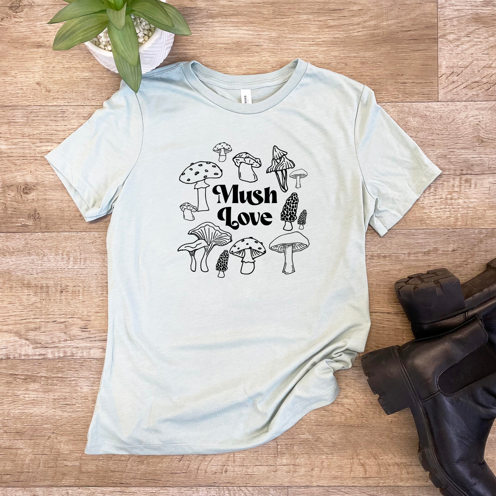 a t - shirt with mushrooms on it and a plant next to it