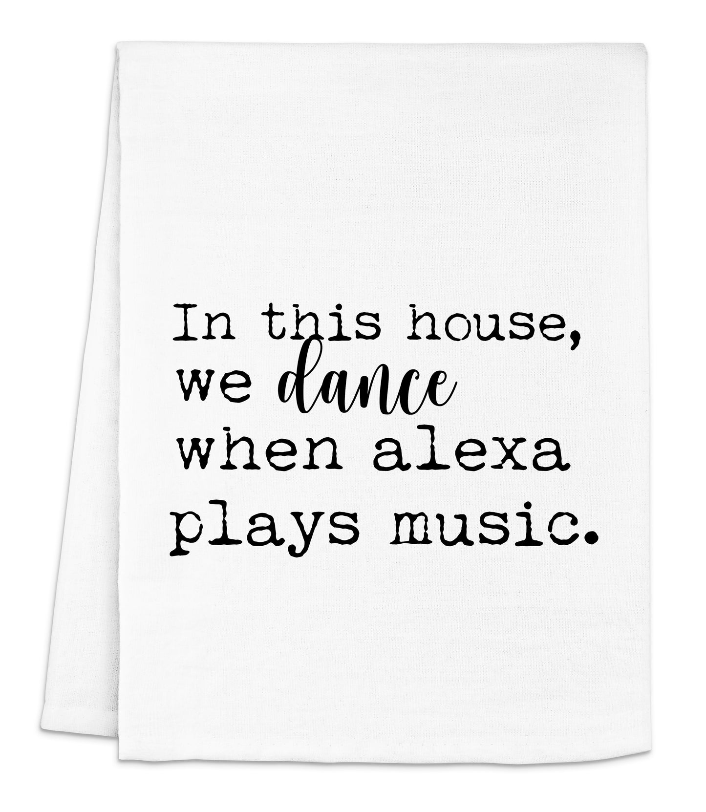 a white dish towel with black lettering that says, in this house, we dance