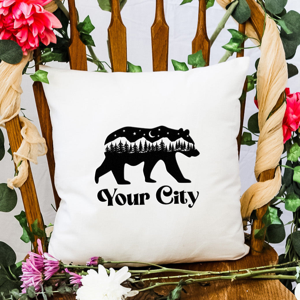 a bear pillow sitting on top of a wooden chair